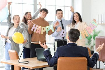 Group of business people greeting their colleague at birthday party in office