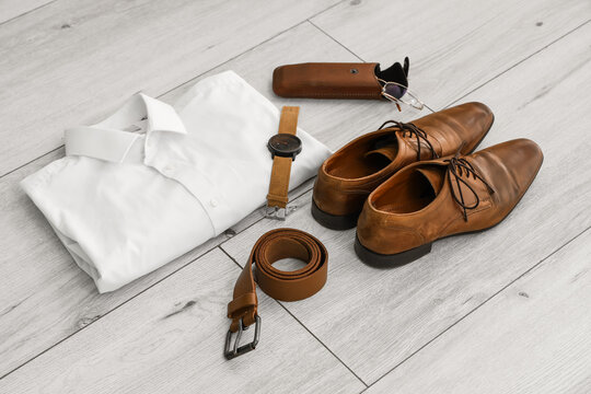 Stylish male clothes with accessories on white wooden background