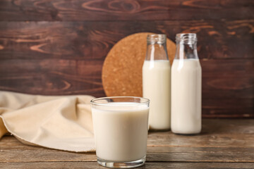 Glass of fresh milk on wooden background