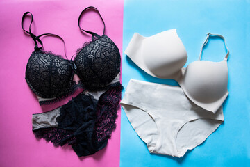 Flat top view. Lace set of black and beige underwear on a pink background. Basic minimalistic beige nude seamless set with a bra and panties on a blue background. Fashion. Which set will you choose - obrazy, fototapety, plakaty