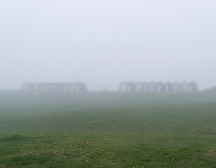 Fototapeta na wymiar Blyth beach huts in mist