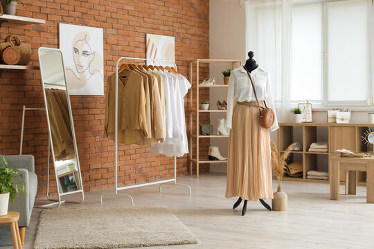 Interior of modern boutique with stylish female clothes and accessories