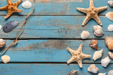 Seashells and starfishes on blue wooden background