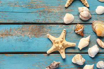 Seashells and starfishes on blue wooden background