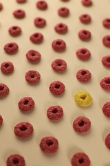 delicious sweet healthy breakfast corn flakes in rings of different colors yellow and pink on different backgrounds. for advertising intros, labels, menus, banners, and more