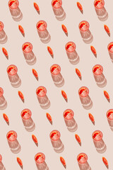 Creative pattern made of glass of fresh lemonade, water or cocktail and slice of red blood orange on pastel beige backgound with shadow. Summer refreshment concept. Sunlit flat lay. 