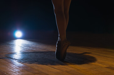 Closeup of Ballerina Legs in Dark Theater on Fingertips. Beautif - 603801667