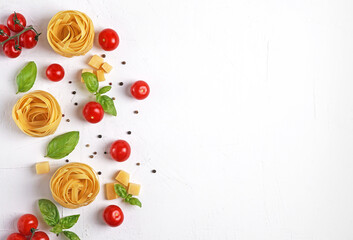 Obraz na płótnie Canvas Pasta ingredients on white background on left side. Red cherry tomatoes, basil, peppercorns. Italian cuisine concept. Healthy vegetarian diet. Flat lay, copy space