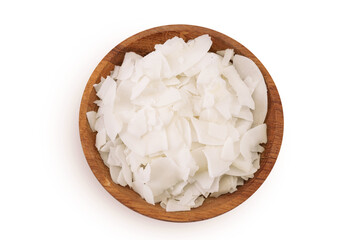 Coconut flakes or chips in wooden bowl isolated on white background. Top view. Flat lay