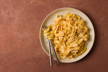 Fettuccine, tagliatelle, in creamy garlic sauce, Italian traditional cuisine, pasta carbonaro,