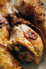 Fried chicken legs lie on a plate after cooking