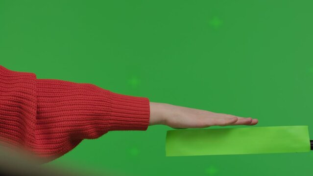 Close Up Side View Of Female Hand Laying On Something Imaginary Virtual And Invisible On Green Screen Chroma Key Background