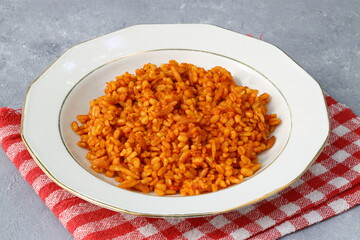 Traditional turkish bulgur pilaf with tomato sause in plate (Turkish name; meyhane pilavi)