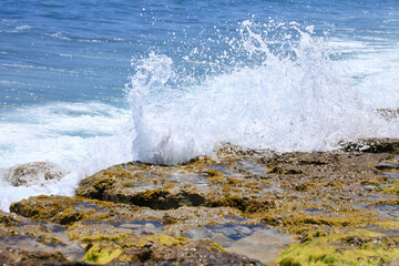 Waves crashing rocks on the shore