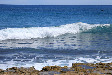 Waves crashing rocks on the shore