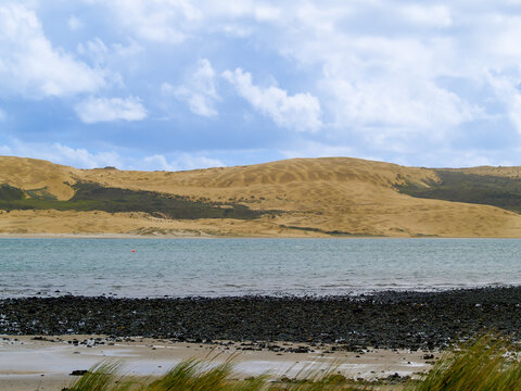 Sand dune patterns in landscape across bay in Opononi