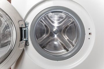 Inside of washing machine. Rotating inner tub. Material metal. Close-up of electrical household...