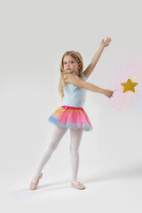 Naklejka premium Studio portrait of beautiful little princess holding star shaped magic wand