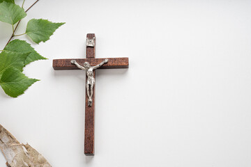 Christian Pentecost. Whit Sunday. A cross with a birch branch on a white, green, red and black background.