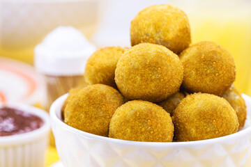 typical Brazilian fritter, savory fried in oil, with cheese, cassava, corn, cornmeal or aipin flavors, crispy and round dumpling served hot.
