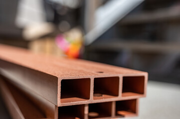 End section of plastic manufactured to resemble wood in prefabricated construction