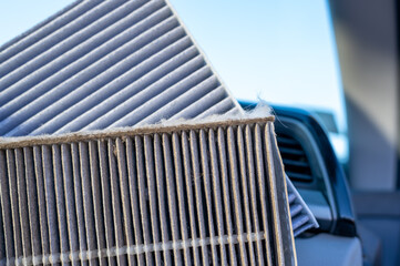 Side-by-side comparison of a dirty and clean automotive cabin filter