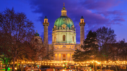 Festive cityscape - view of the Christmas Market on Karlsplatz (Charles' Square) and the Karlskirche (St. Charles Church) in the city of Vienna, Austria