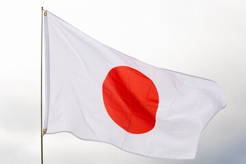 Flag of Japan flying against a blue sky