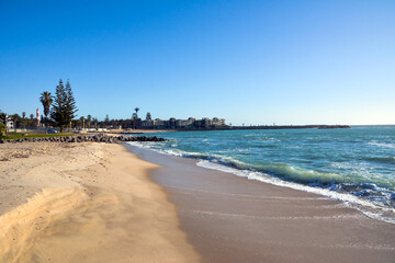 An empty beach with hotels in the far background. Summer travel background