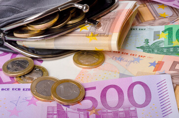 leather wallet with euro banknotes and coins