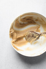 Churros dough in a white bowl, process of making churros, choux pastry dough about to be fried