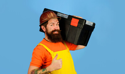 Repair. Repairman in overalls and safety helmet with toolbox showing thumb up. Man with toolbox....