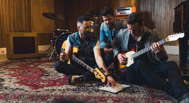 Young indie rock band playing the rehearsal before the concert . High quality photo