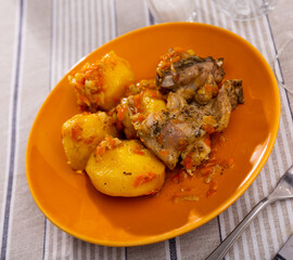 Appetizing homemade stew with rabbit pieces and potatoes. Healthy hearty dinner
