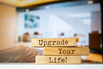 Wooden blocks with words 'Upgrade Your Life'.