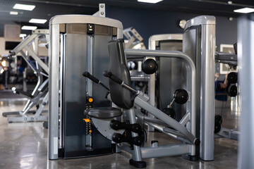 Interior of modern gym with weight training machines for beginners and professional athletes. Beneficial and safe equipment for muscle strengthening and bodybuilding