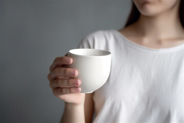 girl holding a white cup, mug in her hands, close up. AI generated content