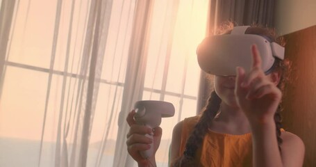 Girl learning using virtual reality headset. Modern education child in virtual reality glasses, girl Immersed in cyberspace, learning in virtual reality. Child playing games On virtual reality device.