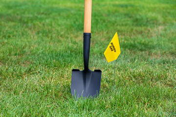 Natural gas utility warning flag with shovel. Notify utility locate company for underground...