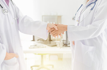 two doctor shaking hand together in hospital, hand in hand, be in unity and teamwork, they feeling...