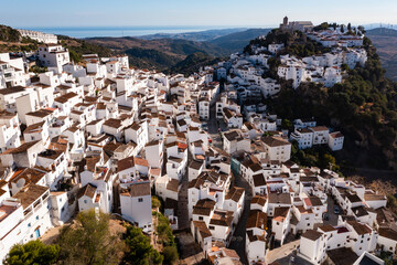 Fototapeta na wymiar Scenic aerial view of small mountain Spanish village of Casares with Moorish cliff-hugging buildings