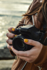 woman holding a camera on the beach