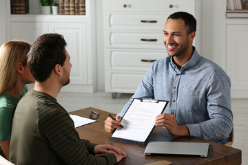 Notary showing contract to couple in office