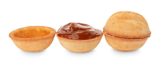 Delicious nut shaped cookies with boiled condensed milk on white background