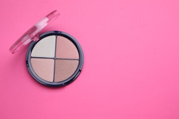 Colorful contouring palette on pink background, top view with space for text. Professional cosmetic product