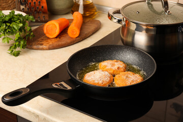 Cooking vegan cutlets in frying pan on stove