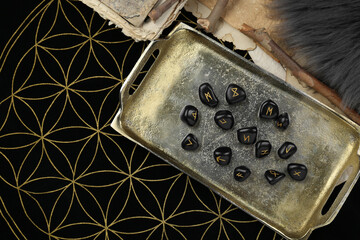 Many black rune stones on divination mat, flat lay. Space for text