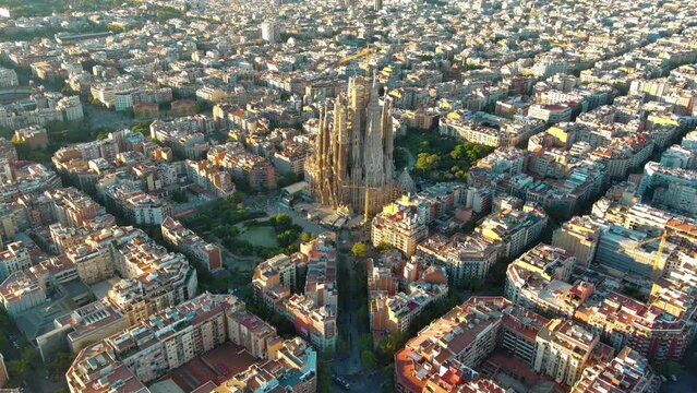 Aerial view of Barcelona Eixample residential district and famous Basilica Sagrada Familia at sunrise. Catalonia, Spain