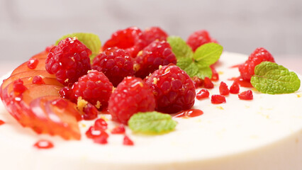 Cheesecake with fresh raspberries and plums