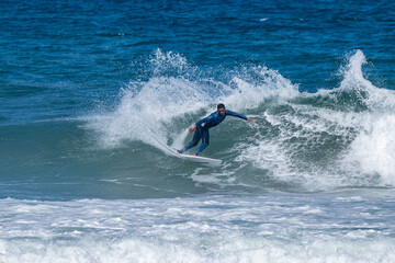 Surfer riding waves in Furadouro Beach
